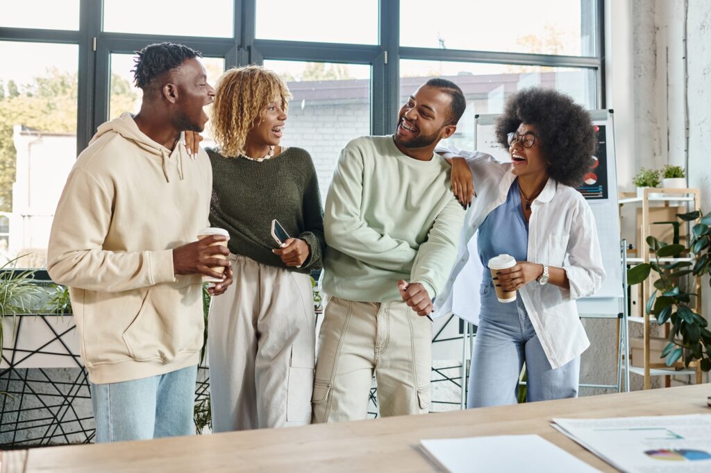 cheerful young people in casual attires discussing actively their project, coworking concept